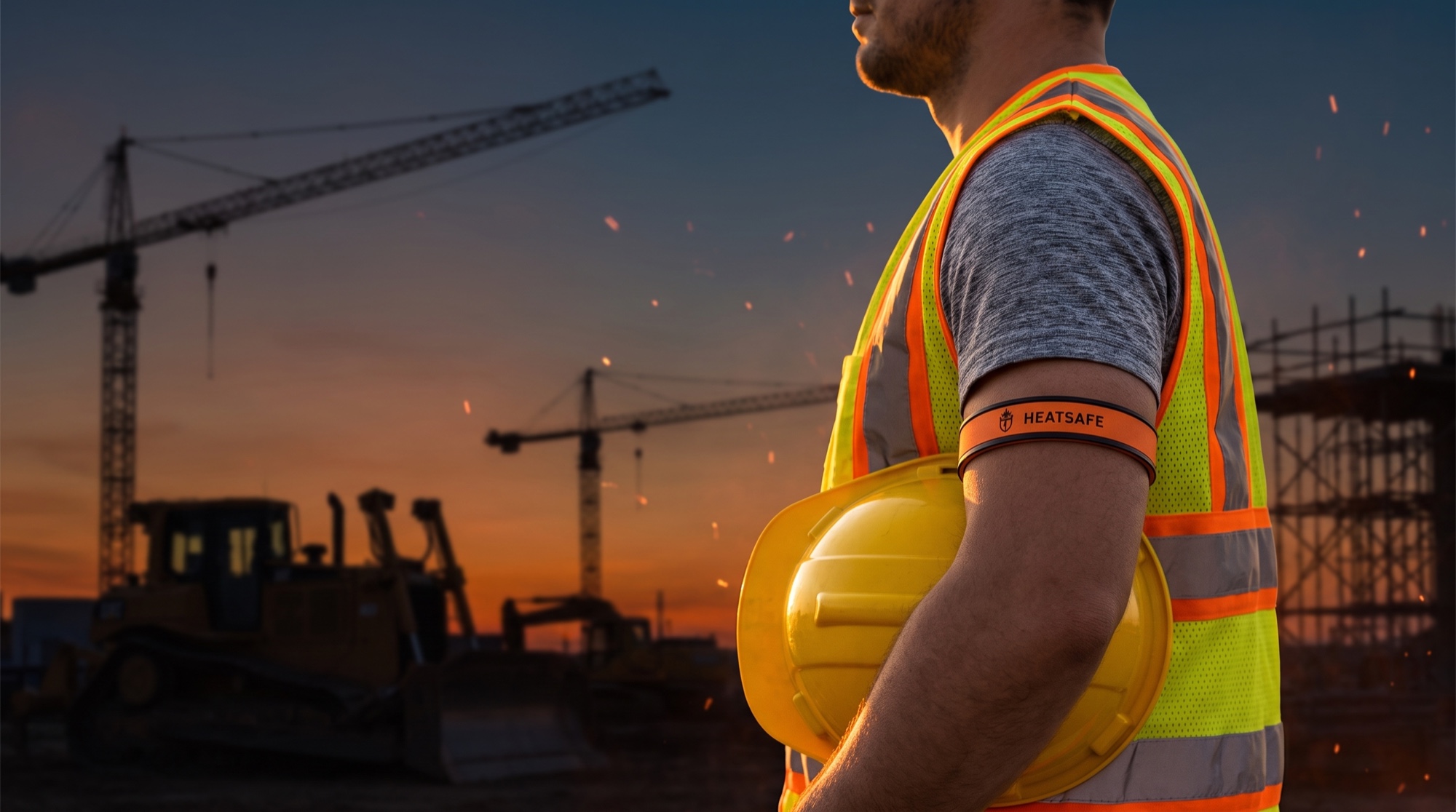 A worker at dusk wearing the HeatSafe band on the bicep, above the elbow.
